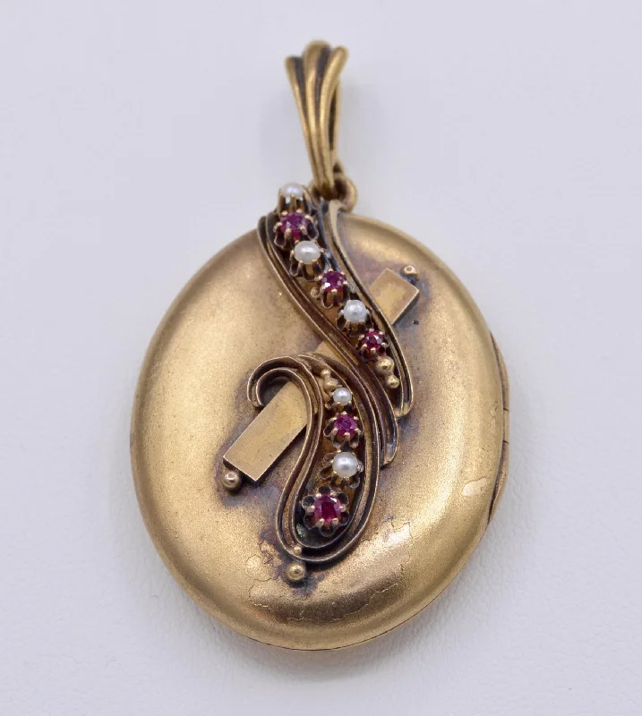 14K yellow gold locket with photo inside decorated with Rubies and seed pearls